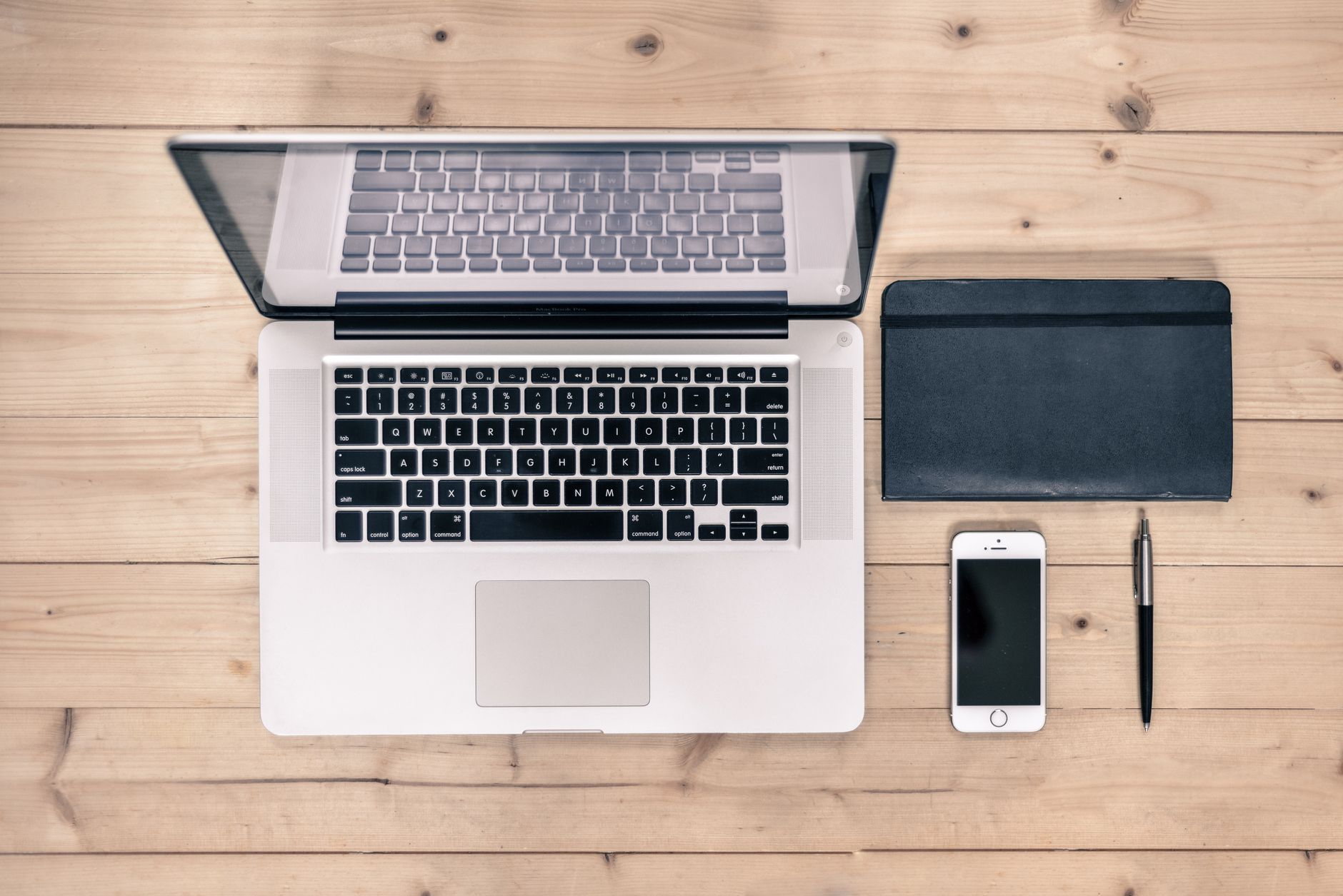 a laptop and a phone on a tidy workspace
